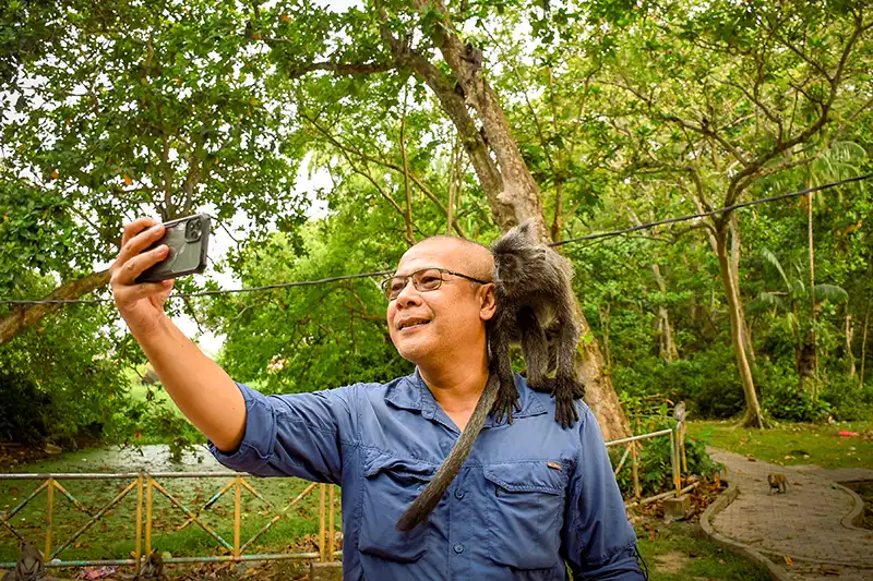 the author of website taking a selfie with silvel leaf monkey in kuala selangor